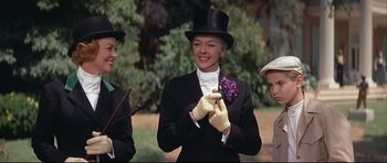 Movie still from “Auntie Mame” (1958), directed by Morton DaCosta – A group of people wearing hats and gloves; Medium shot, Low angle