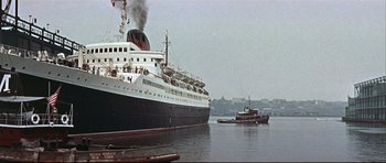 Movie still from “Auntie Mame” (1958), directed by Morton DaCosta – A large cruise ship in a body of water; Extreme Wide shot, Low angle