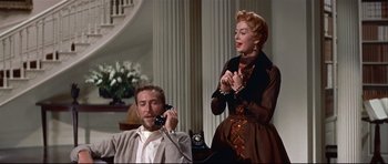 Movie still from “Auntie Mame” (1958), directed by Morton DaCosta – A man and a woman talking on a phone; Medium shot, Low angle