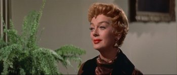 Movie still from “Auntie Mame” (1958), directed by Morton DaCosta – A person wearing a suit and tie; Close Up shot, Low angle
