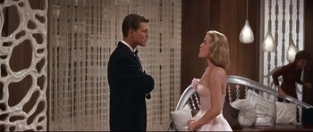 Movie still from “Auntie Mame” (1958), directed by Morton DaCosta – A man and a woman standing next to each other; Medium shot, Low angle