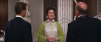 Movie still from “Auntie Mame” (1958), directed by Morton DaCosta – An older woman wearing a green dress and a green jacket; Medium shot, Low angle