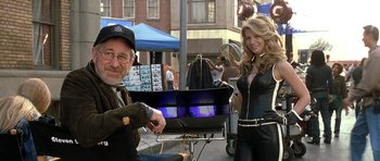 Movie still from “Austin Powers in Goldmember” (2002), directed by Jay Roach – A man sitting next to a beautiful blonde woman; Medium shot, Over the shoulder angle