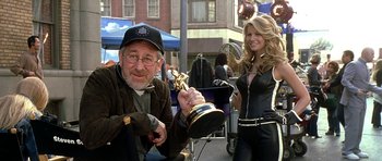 Movie still from “Austin Powers in Goldmember” (2002), directed by Jay Roach – A man sitting next to a woman holding an award; Medium shot, Over the shoulder angle
