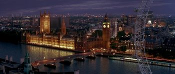 Movie still from “Austin Powers in Goldmember” (2002), directed by Jay Roach – A view of a city at night with a clock tower in the middle of the city; Extreme Wide shot, High angle