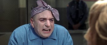 Movie still from “Austin Powers in Goldmember” (2002), directed by Jay Roach – A bald man with a bandana on his head; Close Up shot, Low angle