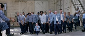 Movie still from “Austin Powers in Goldmember” (2002), directed by Jay Roach – A group of men standing next to each other; Wide shot, Low angle