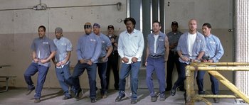 Movie still from “Austin Powers in Goldmember” (2002), directed by Jay Roach – A group of men standing next to each other; Wide shot, Low angle