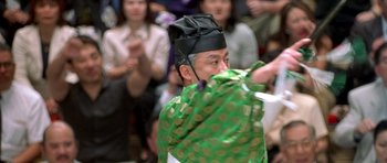 Movie still from “Austin Powers in Goldmember” (2002), directed by Jay Roach – A man wearing a green and black hat and a green and black outfit; Close Up shot, Low angle