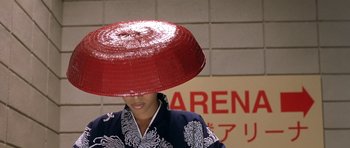 Movie still from “Austin Powers in Goldmember” (2002), directed by Jay Roach – A person with a hat in front of a wall; Close Up shot, High angle