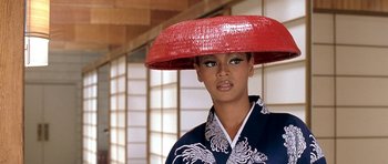 Movie still from “Austin Powers in Goldmember” (2002), directed by Jay Roach – A woman in a kimono and a red hat; Close Up shot, High angle