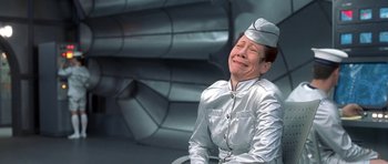 Movie still from “Austin Powers in Goldmember” (2002), directed by Jay Roach – An older woman in a silver uniform laughing; Medium shot, Low angle