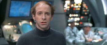 Movie still from “Austin Powers in Goldmember” (2002), directed by Jay Roach – A man in a black sweater is looking to his left; Close Up shot, Over the shoulder angle