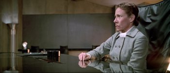 Movie still from “Austin Powers: International Man of Mystery” (1997), directed by Jay Roach – A woman sitting at a table in front of a mirror; Medium shot, Low angle