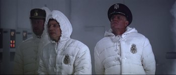 Movie still from “Austin Powers: International Man of Mystery” (1997), directed by Jay Roach – A couple of men standing next to each other; Medium shot, Low angle