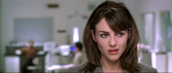 Movie still from “Austin Powers: International Man of Mystery” (1997), directed by Jay Roach – A person wearing a suit and tie; Close Up shot, Over the shoulder angle