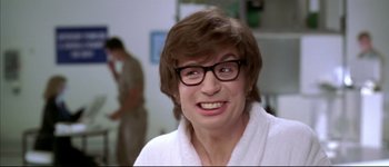 Movie still from “Austin Powers: International Man of Mystery” (1997), directed by Jay Roach – A woman with glasses and a towel around her neck; Close Up shot, Low angle