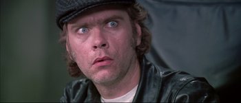 Movie still from “Austin Powers: International Man of Mystery” (1997), directed by Jay Roach – A person wearing a hat and looking surprised; Close Up shot, Low angle