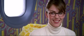 Movie still from “Austin Powers: International Man of Mystery” (1997), directed by Jay Roach – A woman wearing glasses and a white sweater; Close Up shot, Over the shoulder angle