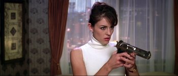 Movie still from “Austin Powers: International Man of Mystery” (1997), directed by Jay Roach – A woman in a white top is holding a camera; Close Up shot, Low angle