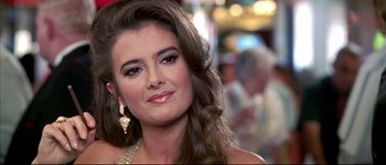Movie still from “Austin Powers: International Man of Mystery” (1997), directed by Jay Roach – A beautiful young lady wearing a gold dress; Close Up shot, Over the shoulder angle