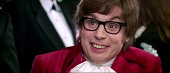 Movie still from “Austin Powers: International Man of Mystery” (1997), directed by Jay Roach – A person wearing glasses and a red jacket; Close Up shot, Overhead angle