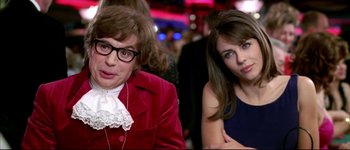 Movie still from “Austin Powers: International Man of Mystery” (1997), directed by Jay Roach – Two women sitting next to each other in a room; Close Up shot, Over the shoulder angle