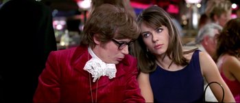 Movie still from “Austin Powers: International Man of Mystery” (1997), directed by Jay Roach – A man and a woman sitting next to each other; Medium shot, Over the shoulder angle