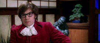 Movie still from “Austin Powers: International Man of Mystery” (1997), directed by Jay Roach – A man in a red jacket and a white shirt; Close Up shot, Low angle