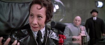 Movie still from “Austin Powers: International Man of Mystery” (1997), directed by Jay Roach – An older woman wearing a black leather jacket; Close Up shot, Low angle