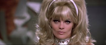 Movie still from “Austin Powers: International Man of Mystery” (1997), directed by Jay Roach – A person with long blonde hair; Close Up shot, Low angle