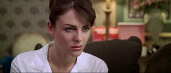 Movie still from “Austin Powers: International Man of Mystery” (1997), directed by Jay Roach – A person sitting on a chair; Close Up shot, Over the shoulder angle