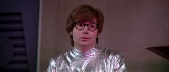 Movie still from “Austin Powers: International Man of Mystery” (1997), directed by Jay Roach – A man in a silver suit with glasses; Close Up shot, Low angle