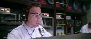 Movie still from “Austin Powers: International Man of Mystery” (1997), directed by Jay Roach – A man in a white shirt holding a microphone; Close Up shot, Low angle