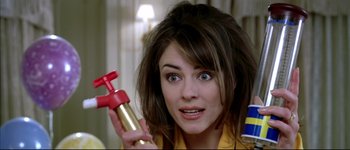 Movie still from “Austin Powers: International Man of Mystery” (1997), directed by Jay Roach – A woman holding a spray bottle in her hand; Close Up shot, Over the shoulder angle