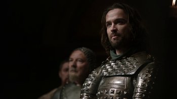 Movie still from “Game of Thrones” (2011), created by D.B. Weiss – A man in a metal armor stands next to another man in a metal armor; Close Up shot, Low angle