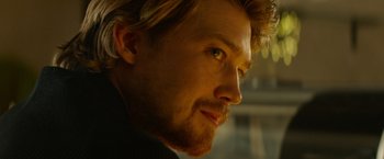 Movie still from “Stars at Noon” (2022), directed by Claire Denis – A person with a beard; Close Up shot, Over the shoulder angle