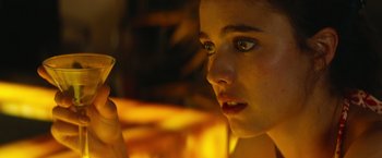 Movie still from “Stars at Noon” (2022), directed by Claire Denis – A woman is holding a cigarette in her hand; Extreme Close Up shot, Over the shoulder angle