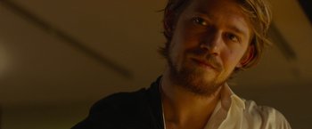 Movie still from “Stars at Noon” (2022), directed by Claire Denis – A person with a beard; Close Up shot, Over the shoulder angle