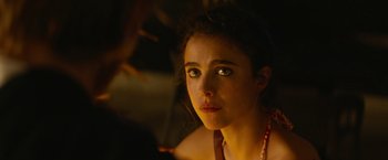 Movie still from “Stars at Noon” (2022), directed by Claire Denis – A person wearing a necklace; Close Up shot, Over the shoulder angle