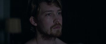 Movie still from “Stars at Noon” (2022), directed by Claire Denis – A person with a beard; Close Up shot, Over the shoulder angle