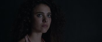 Movie still from “Stars at Noon” (2022), directed by Claire Denis – A person with long curly hair; Close Up shot, Low angle