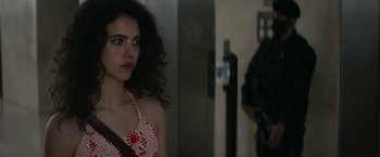 Movie still from “Stars at Noon” (2022), directed by Claire Denis – A young woman in a red and white polka dot dress; Close Up shot, Over the shoulder angle