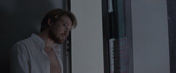 Movie still from “Stars at Noon” (2022), directed by Claire Denis – A person looking out of a window; Close Up shot, Over the shoulder angle