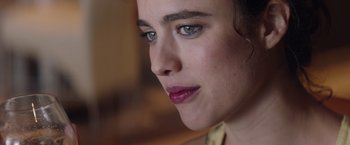 Movie still from “Stars at Noon” (2022), directed by Claire Denis – A woman's face with green eyes; Extreme Close Up shot, Over the shoulder angle