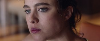 Movie still from “Stars at Noon” (2022), directed by Claire Denis – A woman's face with blue eyes; Extreme Close Up shot, High angle