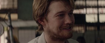 Movie still from “Stars at Noon” (2022), directed by Claire Denis – A person with a beard; Close Up shot, Over the shoulder angle