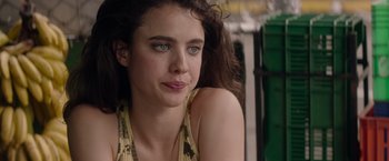 Movie still from “Stars at Noon” (2022), directed by Claire Denis – A person sitting on a chair; Close Up shot, Over the shoulder angle