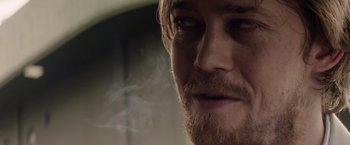 Movie still from “Stars at Noon” (2022), directed by Claire Denis – A person with a beard; Close Up shot, Over the shoulder angle