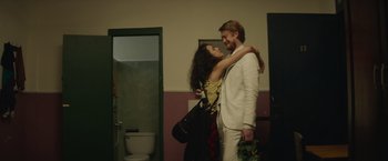 Movie still from “Stars at Noon” (2022), directed by Claire Denis – A man and a woman standing next to each other in a bathroom; Medium shot, Over the shoulder angle